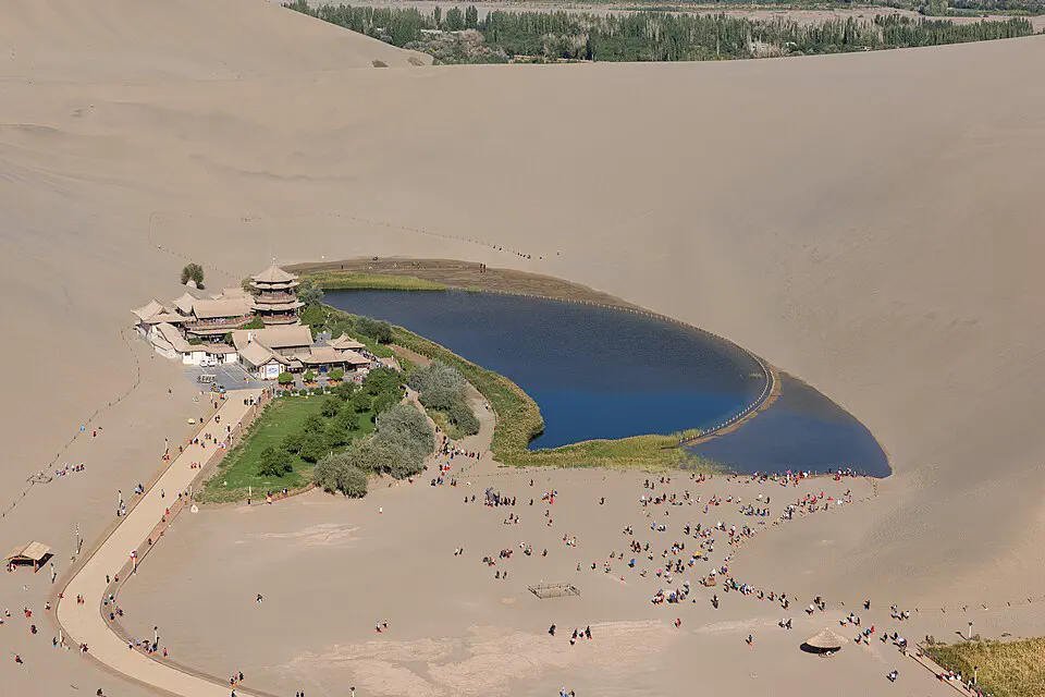 Crescent Lake oasis enclosed by the Singing Sand Dunes near Dunhuang
