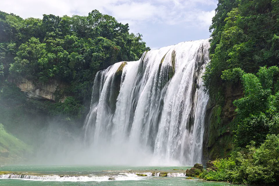 Huangguoshu Waterfall plunging through green forest in Guizhou