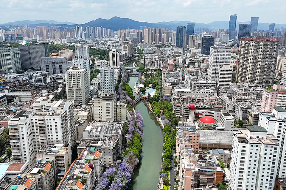 Kunming city center and canal stretching toward mountain ridges