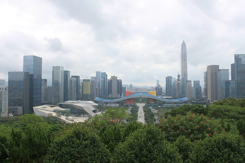Shenzhen Civic Center and the Futian skyline seen from a green hillside