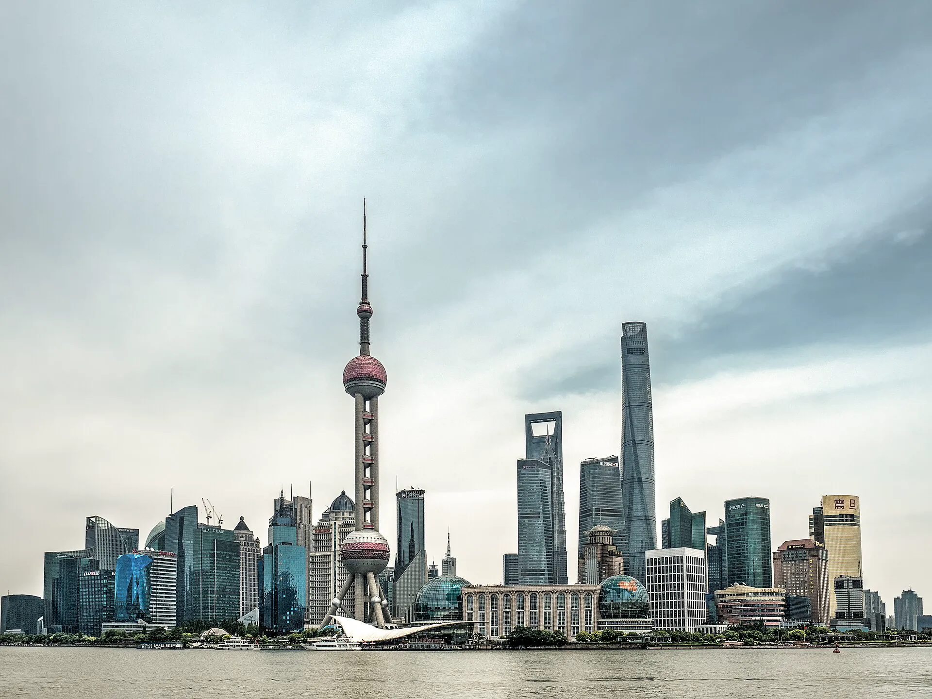 Lujiazui skyline and Oriental Pearl Tower beneath a bright overcast sky