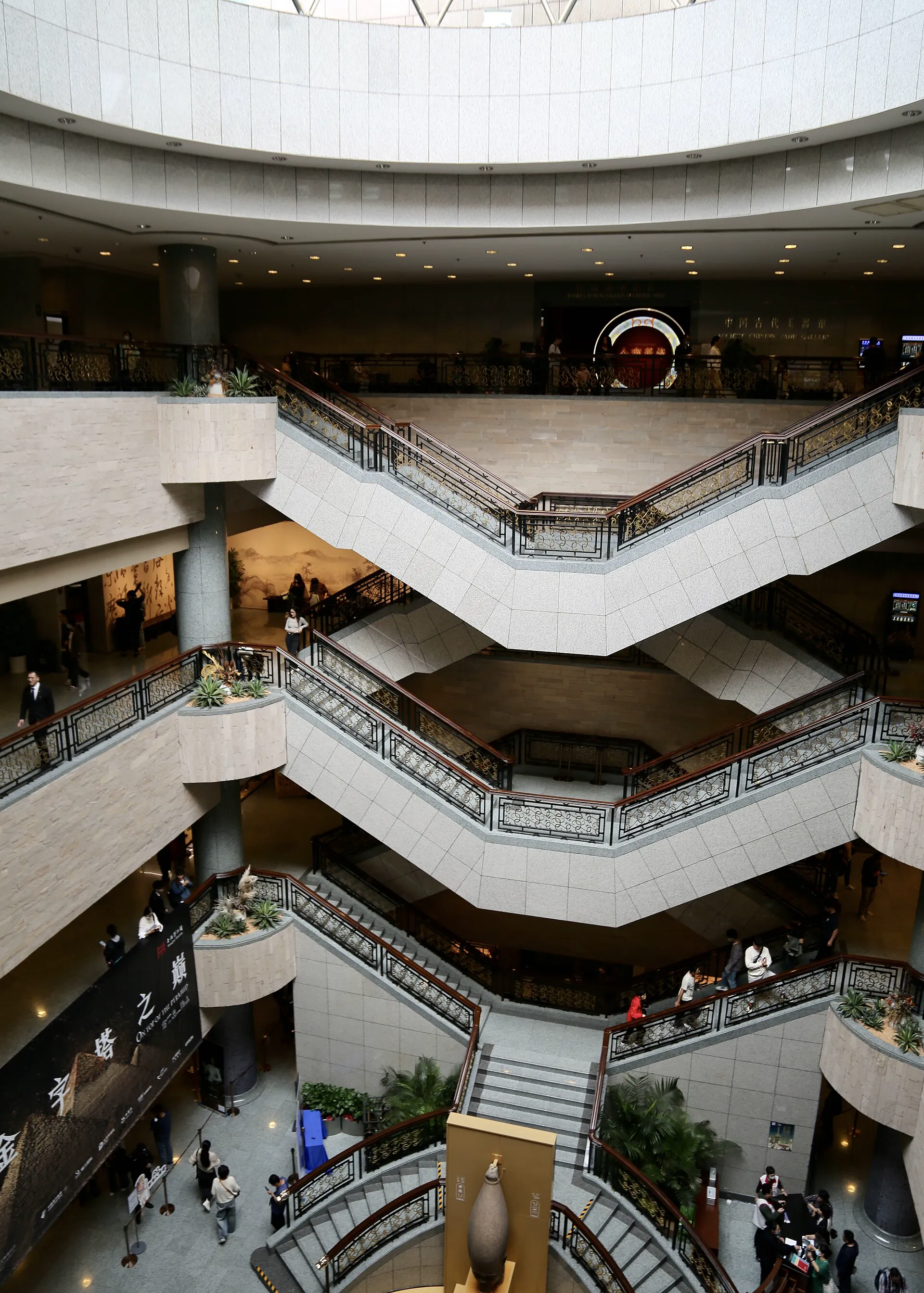 Visitors moving through the angular staircases of Shanghai Museum