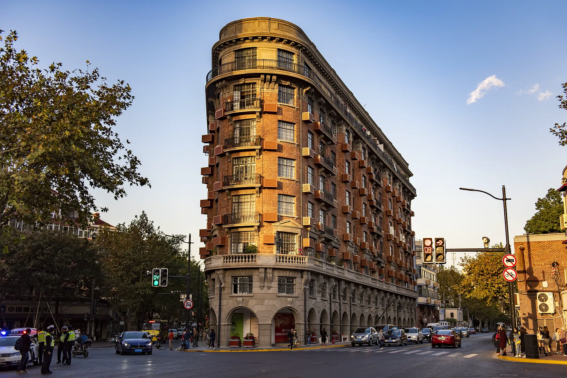 Wukang Mansion at a tree-lined street junction in Xuhui