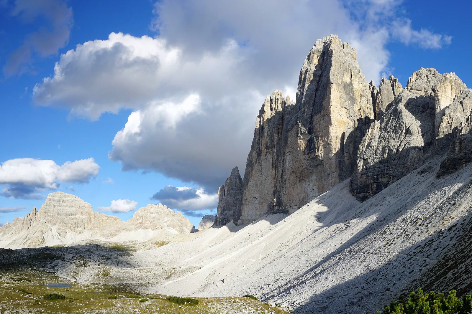 Tre Cime di Lavaredo rising above a Dolomite trail