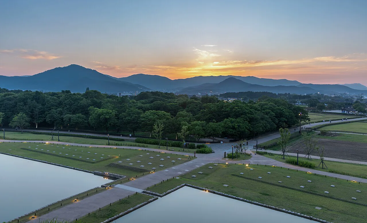 Royal tumuli and low mountains beneath a warm sunset in Gyeongju