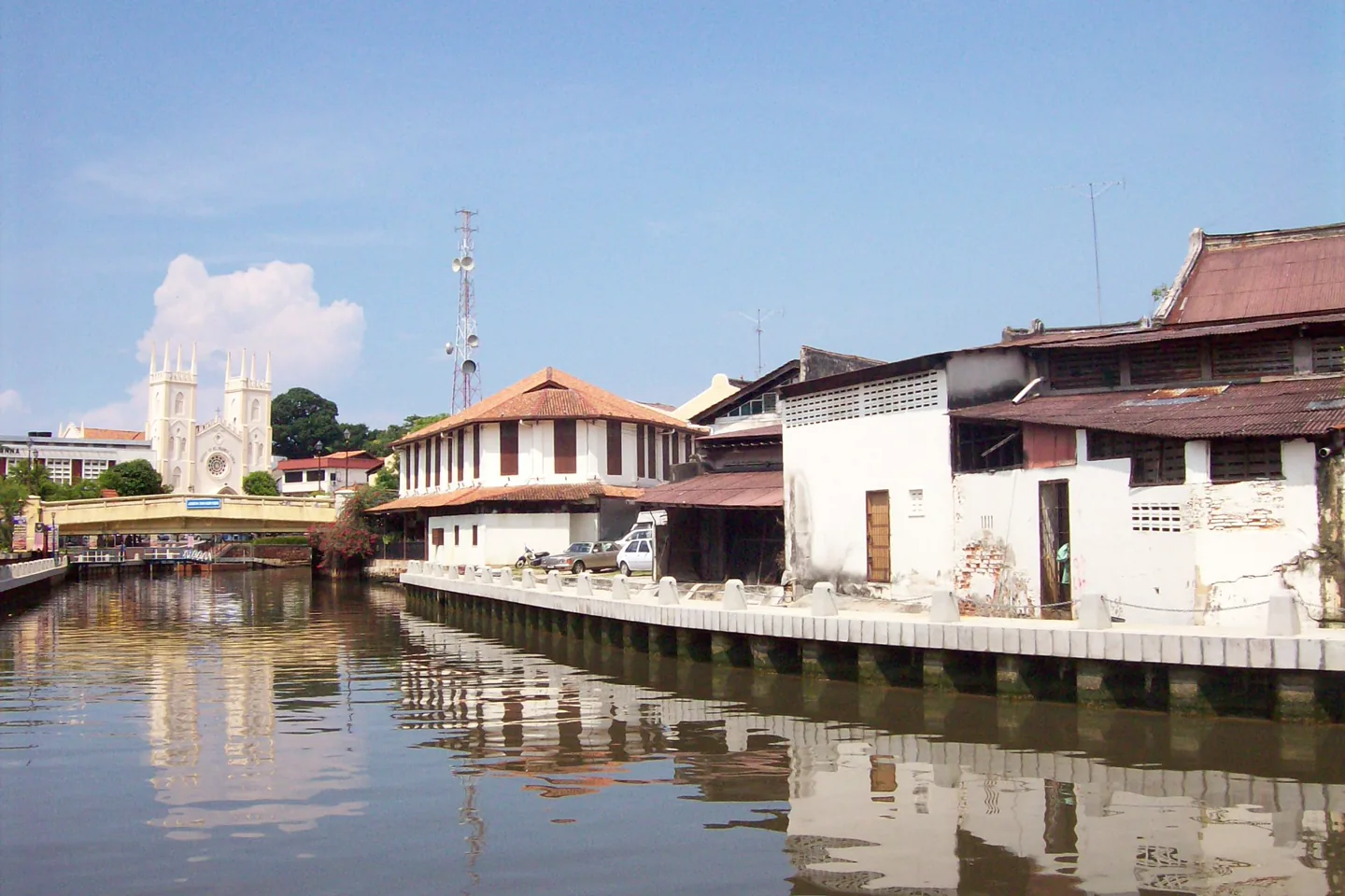 Melaka River beside historic buildings and church towers