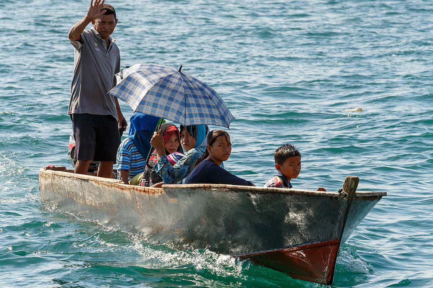 Local family traveling by water taxi across Semporna waters