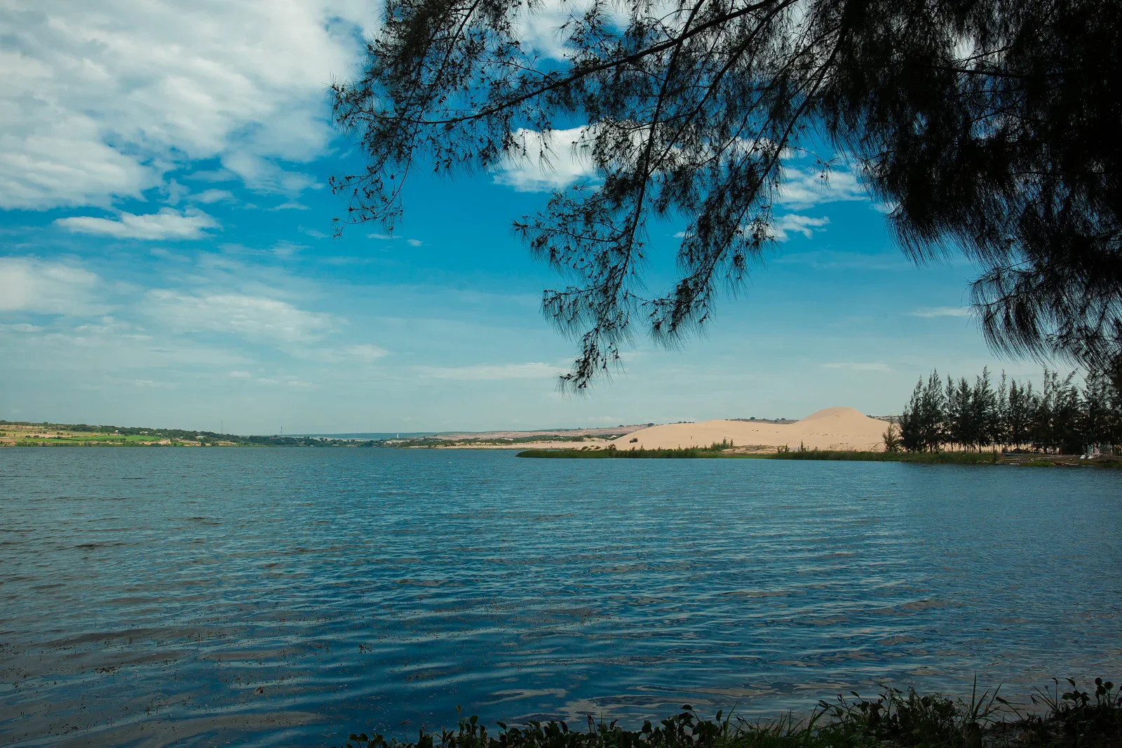 White dunes surrounding Bau Trang lake in Binh Thuan