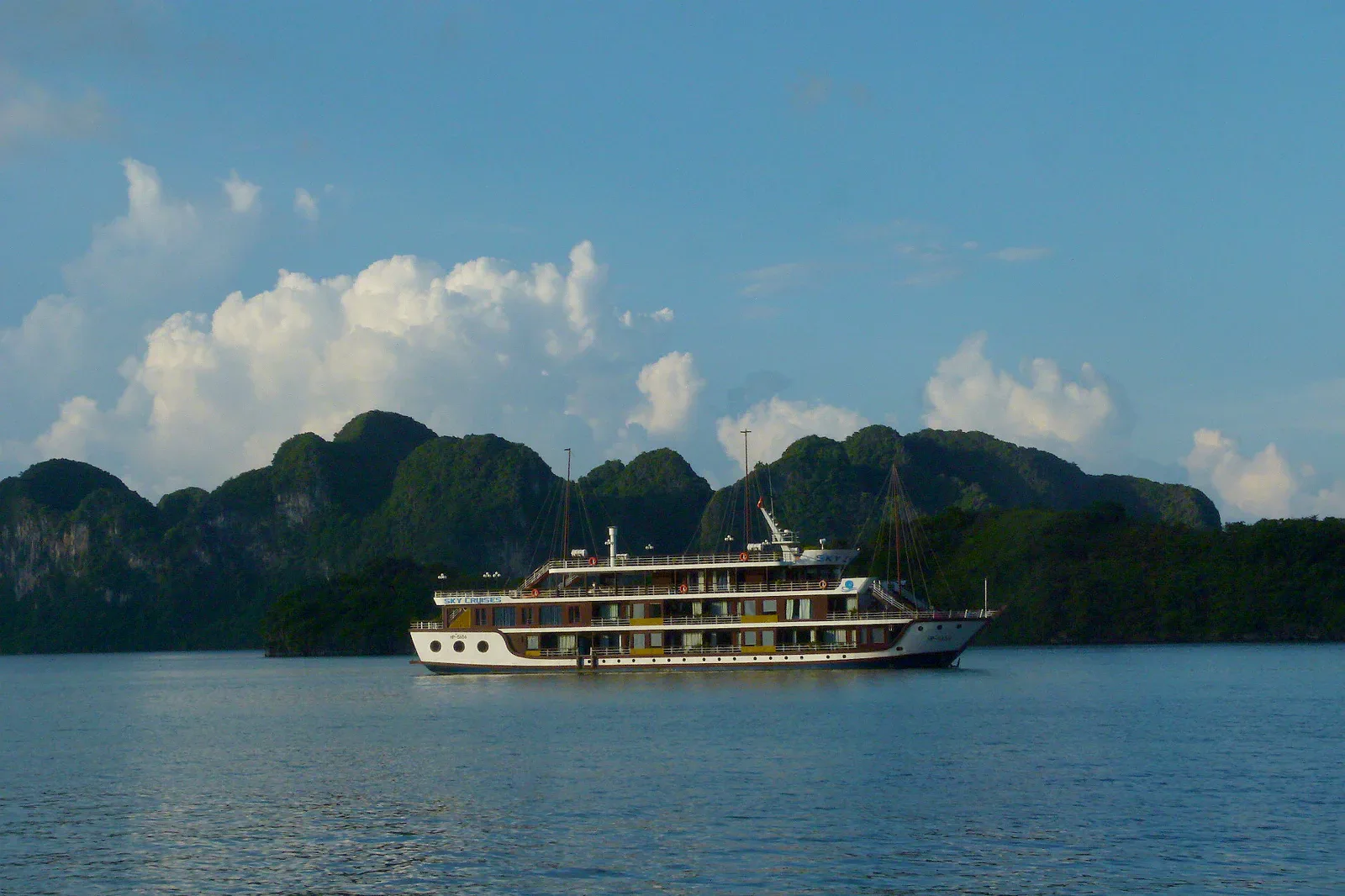 A cruise boat among the limestone islands of Ha Long Bay